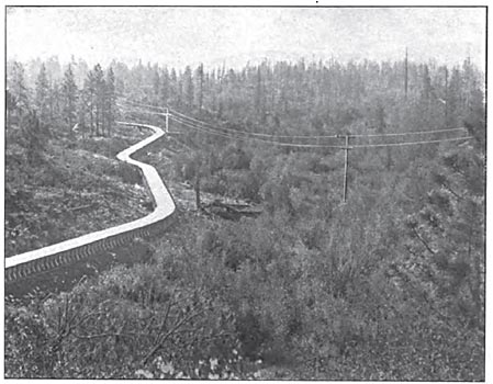 FIG. 8.  PART OF THE FLUME CONNECTING CASCADE RESERVOIR WITH THE FOREBAY.  A PART OF THE TRANSMISSION LINE IS ALSO SHOWN.