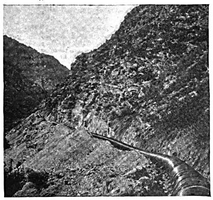 FIG. 1  THE PIPE LINE ALONG THE SIDE OF THE CANYON.