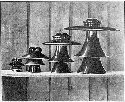 THE FOUR INSULATORS SHOWN ABOVE RANGE IN SIZE FROM 5 TO 21 INCHES IN DIAMETER AND FROM 5 1/8 TO 18 5/8 INCHES HIGH.