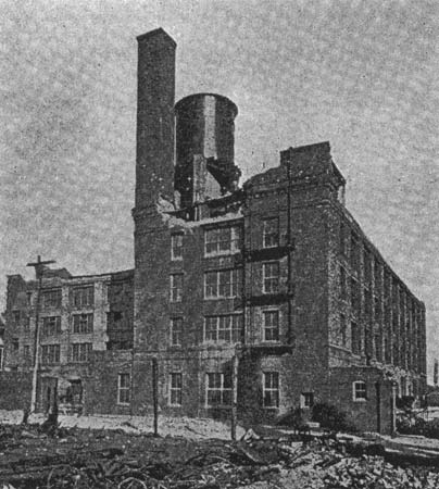 This picture shows a portion of the rear wall, which fell at first earthquake shock. The brick chimney was damaged and is now being taken down. Water tank, containing 70,000 gallons, was not thrown down./BUILDING OF CALIFORNIA ELECTRICAL WORKS, FOLSOM STREET, SAN FRANCISCO, WHICH WENT THROUGH EARTHQUAKE AND FIRE WITH ONLY SLIGHT DAMAGE.