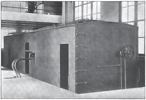 FIG. 14.  A SUB-STATION CAR CONNECTED UP IN THE INTERIOR OF A PERMANENT SUB-STATION. THE CAR IS BUILT OF STEEL AND RESEMBLES A FREIGHT CAR IN APPEARANCE