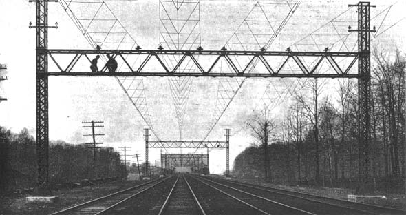 Each catenary consists of two 1/2-inch steel cables carried on insulators on the top of the trusses. The copper trolley wire is suspended from the cables and held in level and alignment by triangles made of 3/8-inch pipe./The Trolley Lines of the New York, New Haven & Hartford Railroad.