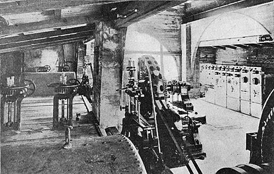 FIG. 4.—VIEW IN POWER HOUSE, SHOWING  WATER WHEEL HOUSINGS, GENERATORS AND SWITCHBOARD.