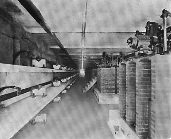 LONGITUDINAL VIEW OF THE NORTH SIDE OF THE THIRD FLOOR OF THE CONCRETE SWITCH HOUSE, SHOWING TO THE LEFT ONE SET OF 2300 - VOLT BUSBARS AND WITH CONCRETE BARRIERS, AND TO THE RIGHT THE REMOTE CONTROL GENERATOR AND TRANSFORMER 2300- VOLT OIL SWITCHES. THIS ENTIRE ARRANGEMENT IS DUPLICATED ON THE SOUTH SIDE OF THIS FLOOR.