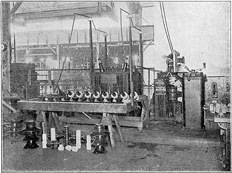 FIG. I  GENERAL VIEW OP AN INSULATOR TESTING DEPARTMENT / Showing transformer, controlling apparatus, insulators in water trough and bushings fitted with jigs on testing rack, also some of the types of insulators tested.