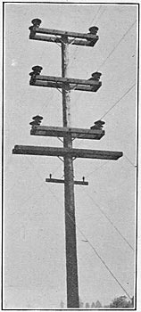 Pole-top construction where two lines are on the same pole, showing guard wires over railroad. (60,000 volts)