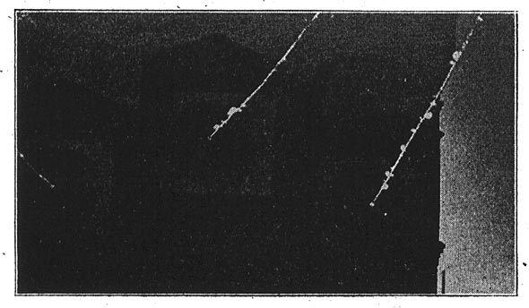 Showing Luminous Discharge and Brush Displays. The Wires are Eight Feet Apart/FIG. 12. 110,000-VOLT SUB-STATION ENTRY AT NIGHT