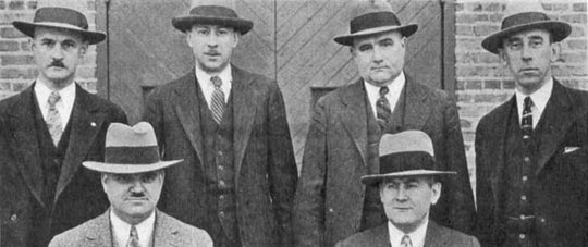 Front row, left to right: John A. Le Mieux, James F. Toy (Gen. Mgr.).  Back row, left to right: E. L. Crosby, H. G. Cooper, Walter Harvey, J. M. Weaver.  Locke Insulator Corp., Baltimore, Md.