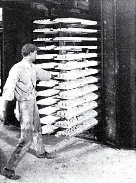 A "Rack" Suspended from an Overhead "I" Beam Loaded with Green Ware Emerging from the Dryer.