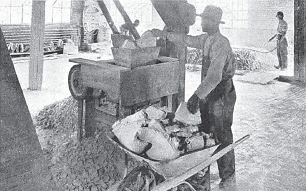 A Small Hand Fed Breaker, Used Temporarily to Break Up the Thoroughly Dried Filter Cakes Is Shown in This Photo.